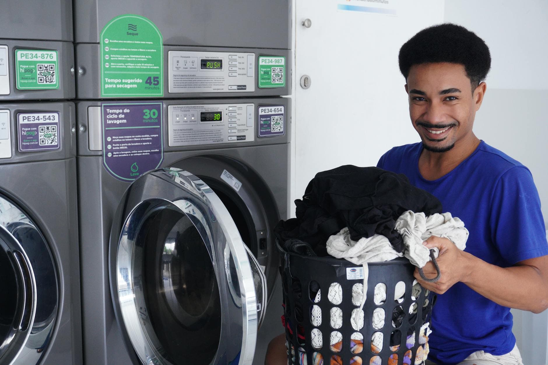 Customer using modern washing machines at The Latte Launderette